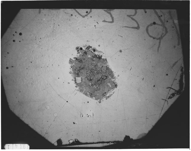 Black and white photograph of Apollo 12 sample 12033,91; Thin Section photograph displaying grain mount.