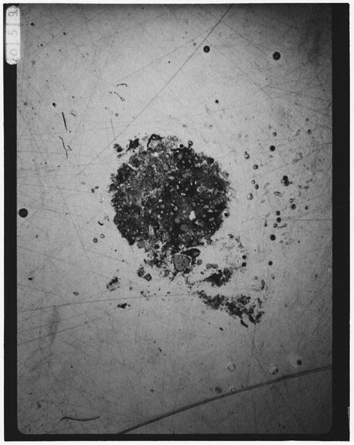 Black and white photograph of Apollo 12 sample 12033,87; Thin Section photograph displaying grain mount.