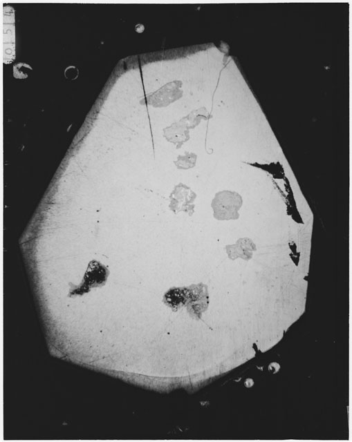 Black and white photograph of Apollo 12 sample 12070,161; Thin Section photograph displaying grain mount.