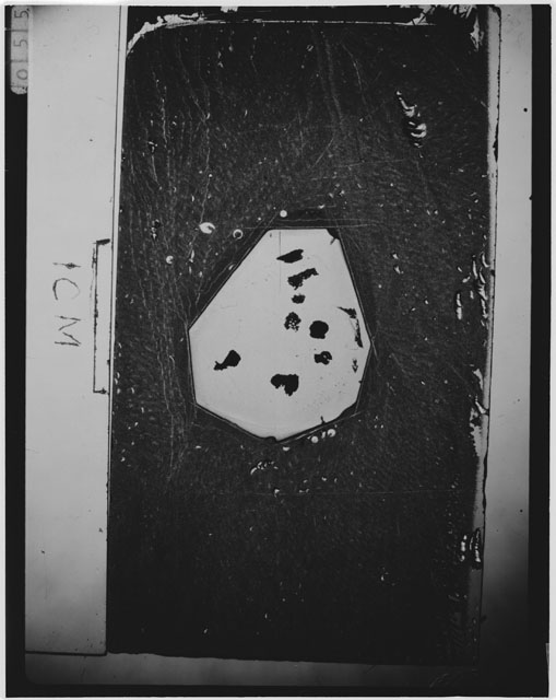 Black and white photograph of Apollo 12 sample 12070,161; Thin Section photograph displaying grain mount.