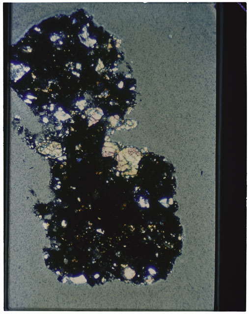 Color photograph of Apollo 12 sample 12070,160; Thin Section photograph displaying grain mount using cross nichols light.