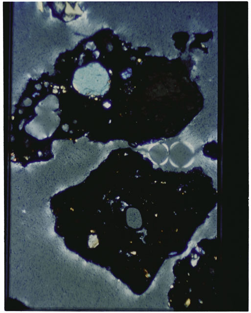 Color photograph of Apollo 12 sample 12070,162; Thin Section photograph displaying grain mount using cross nichols light.