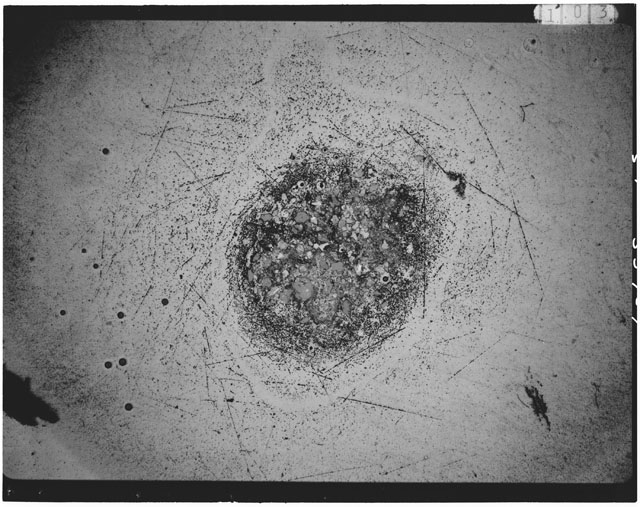 Black and white photograph of Apollo 12 sample 12033,88; Thin Section photograph displaying grain mount.