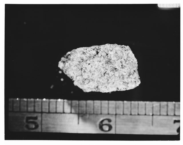 Black and white photograph of Apollo 14 Sample(s) 14053,3; Processing photograph displaying a chip.
