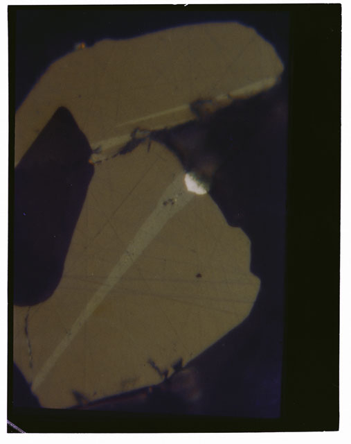 Color Thin Section photograph of Apollo 14 Sample(s) 14310,10 using cross nichols light at 100X magnification.