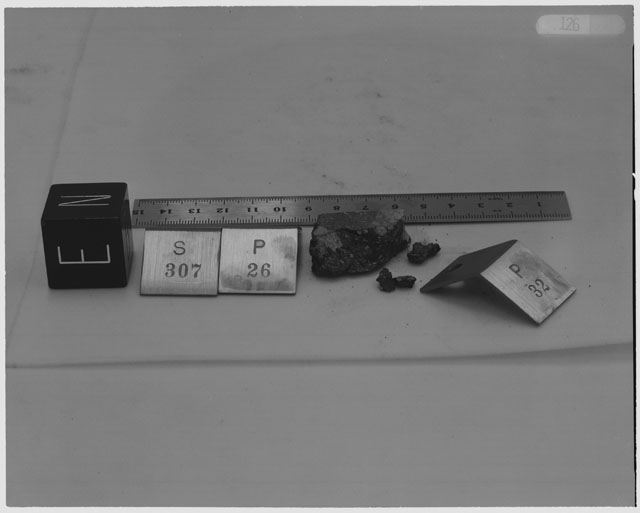 Black and white photograph of Apollo 14 Sample(s) 14307,26,32; Processing photograph displaying post chip sample with an orientation of E,N.