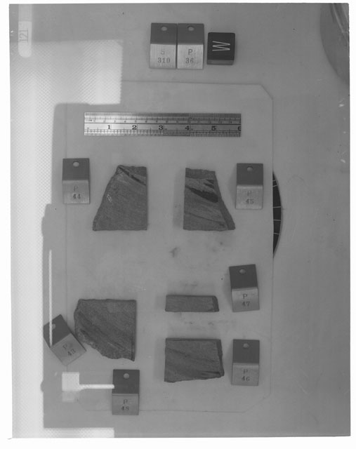 Black and white photograph of Apollo 14 Sample(s) 14310,36,43-47; Processing photograph displaying post slabbing group with an orientation of W.