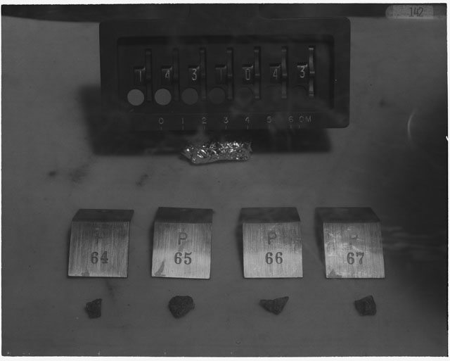 Black and white photograph of Apollo 14 Sample(s) 14310,43,64-67; Processing photograph displaying a group of chips.