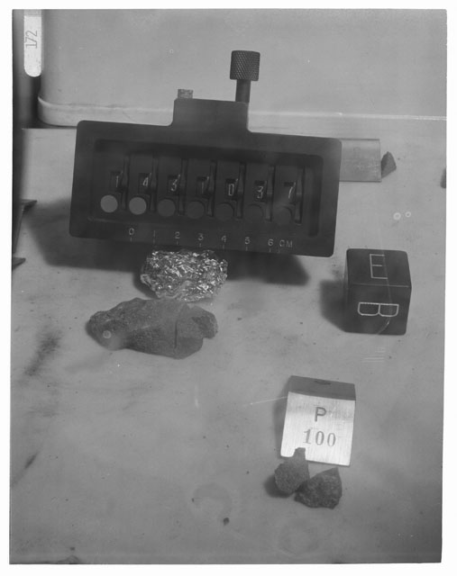 Black and white photograph of Apollo 14 Sample(s) 14310,37,100; Processing photograph displaying reconstruction with an orientation of E,B.