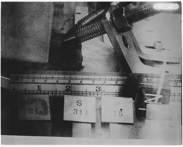 Black and white photograph of Apollo 14 Sample(s) 14311,15,21; Processing photograph displaying cutting with an orientation of E,N.