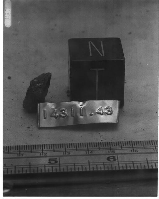 Black and white photograph of Apollo 14 Sample(s) 14311,43; Processing photograph displaying a chip with an orientation of N,T.