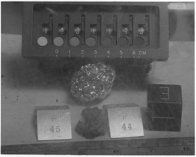 Black and white photograph of Apollo 14 Sample(s) 14311,43-45; Processing photograph displaying post chip sample with an orientation of T,E.