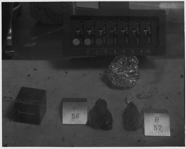 Black and white photograph of Apollo 14 Sample(s) 14311,55-57; Processing photograph displaying post chip sample with an orientation of T,E.