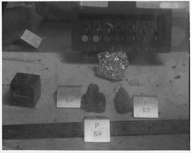 Black and white photograph of Apollo 14 Sample(s) 14311,55-58; Processing photograph displaying post chip sample with an orientation of T,E,S.