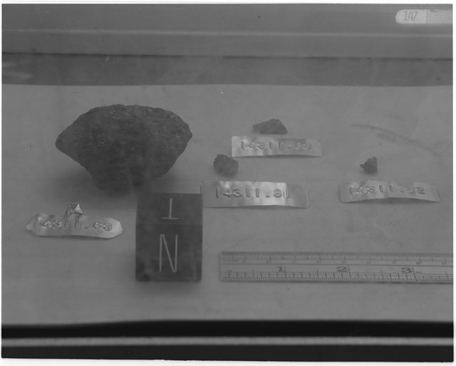 Black and white photograph of Apollo 14 Sample(s) 14311,63,81-83; Processing photograph displaying post chip sample with an orientation of N,T.