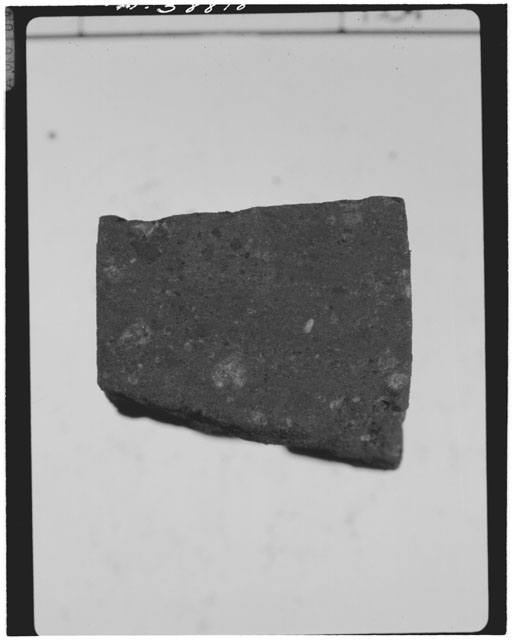 Black and white photograph of Apollo 14 Sample(s) 14313,28; Processing photograph displaying a chip.
