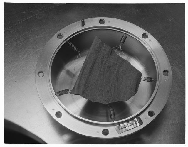 Black and white photograph of Apollo 14 Sample(s) 14310,42; Processing photograph displaying a slab.