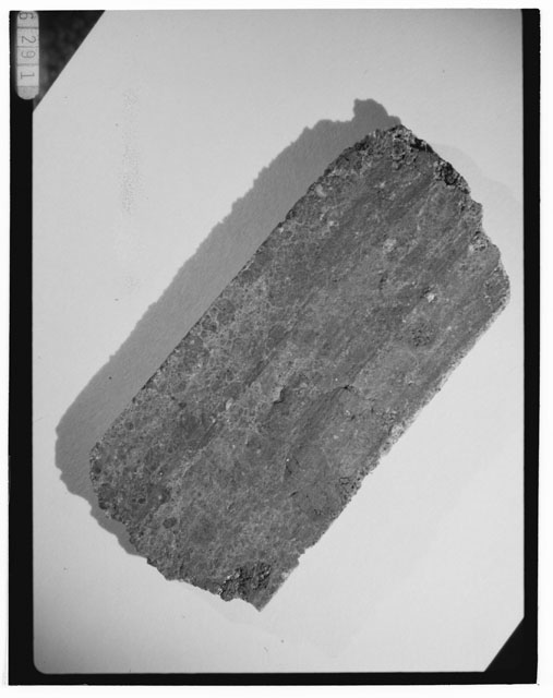 Black and white photograph of Apollo 14 Sample(s) 14305,35; Processing photograph displaying a chip.