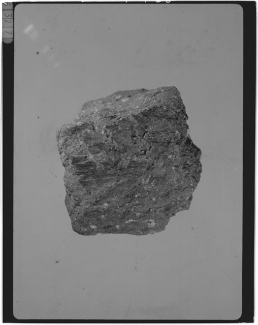 Black and white photograph of Apollo 14 Sample(s) 14047,49; Processing photograph displaying a chip.