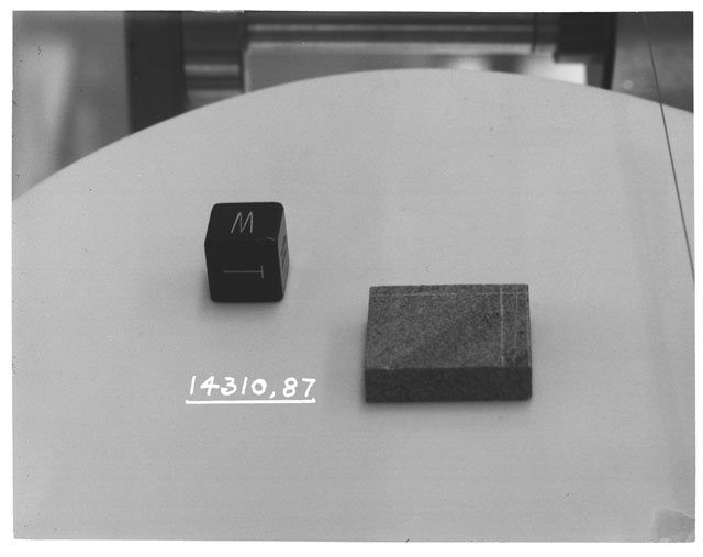 Black and white photograph of Apollo 14 Sample(s) 14310,87; Processing photograph displaying a slab with an orientation of W,T.