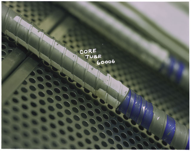 Color photograph of Apollo core tube 60006 in processing lab.