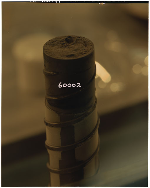 Color photograph of Apollo 16 Core Sample 60002; Processing photograph displaying a drill stem.