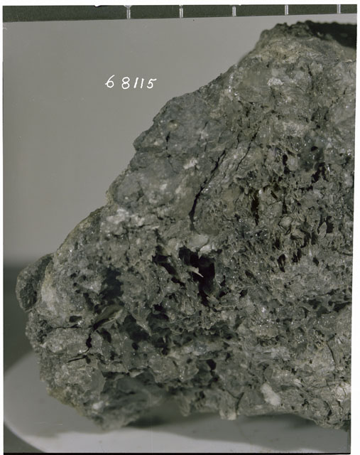 Color photograph of Apollo 16 Sample(s) 68115; Processing photograph displaying close-up view.
