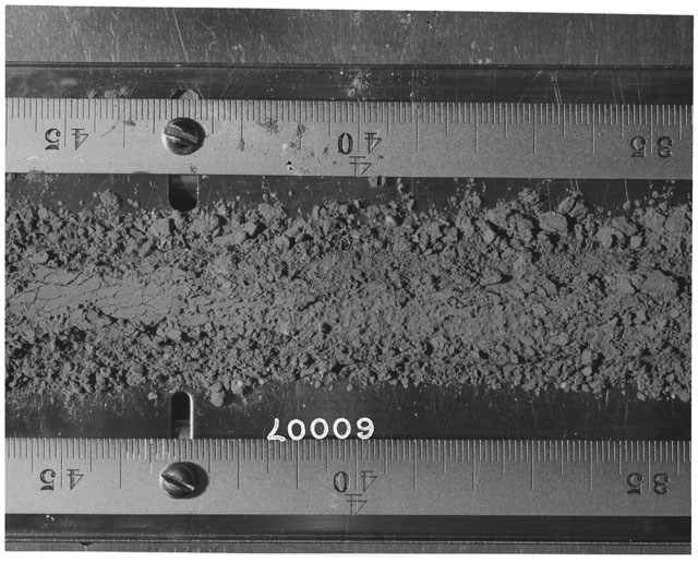 Black and white photograph of Apollo 16 Sample(s) 60007; Processing photograph displaying Core Tube at 35-45 cm depth.