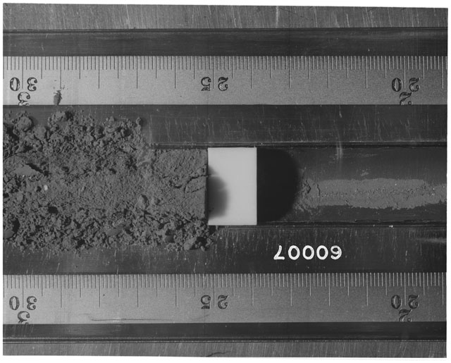 Black and white photograph of Apollo 16 Sample(s) 60007; Processing photograph displaying Core Tube at 19-30 cm depth.