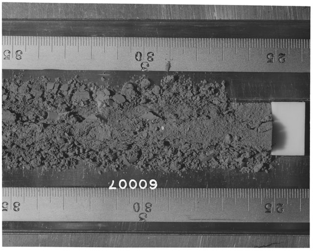 Black and white photograph of Apollo 16 Sample(s) 60007; Processing photograph displaying Core Tube at 25-35 cm depth.