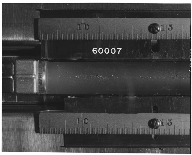 Black and white photograph of Apollo 16 Sample(s) 60007; Processing photograph displaying Core Tube with fines at 7.5-16.5 cm depth.