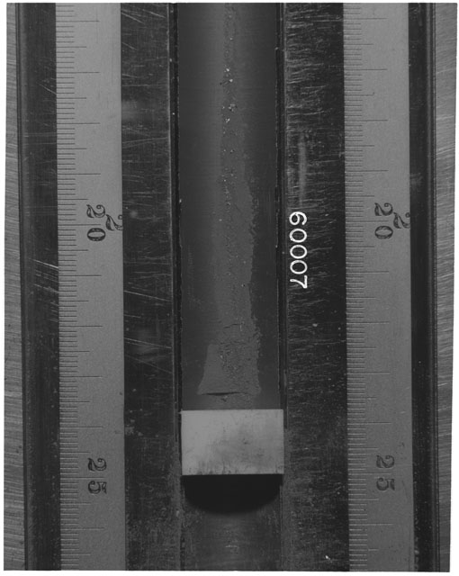 Black and white photograph of Apollo 16 Sample(s) 60007; Processing photograph displaying Core Tube at 16-26.5 cm depth.