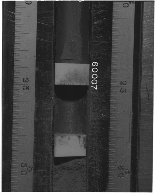 Black and white photograph of Apollo 16 Sample(s) 60007; Processing photograph displaying Core Tube at 20-31 cm depth.