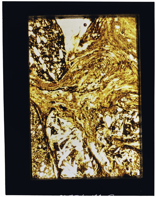 Color photograph of Apollo 16 Sample(s) 68815; 2.5 MM Thin Section photograph using transmitted light.