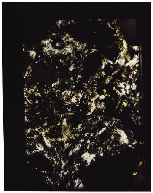 Color photograph of Apollo 16 Sample(s) 68115; 10x magnification of a Thin Section photograph using cross nichols light.