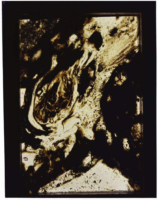 Color photograph of Apollo 16 Sample(s) 68115; 10x magnification of a Thin Section photograph using transmitted light.