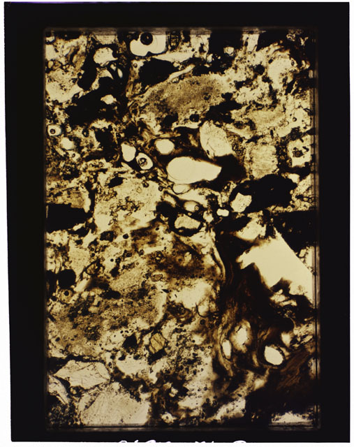 Color photograph of Apollo 16 Sample(s) 68115; 2.5x magnification of a Thin Section photograph using transmitted light.