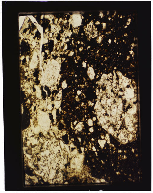 Color photograph of Apollo 16 Sample(s) 68115; 2.5x magnification of a Thin Section photograph using reflected light.
