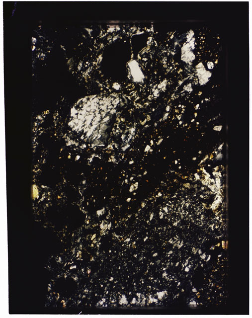 Color photograph of Apollo 16 Sample(s) 68115; 2.5x magnification of a Thin Section photograph using cross nichols light.