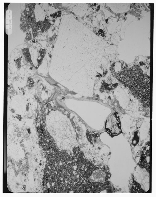Black and white photograph of Apollo 16 Sample(s) 68115,3; 2.5x magnification of a Thin Section photograph using reflected light.