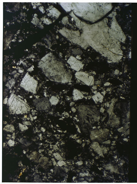 Color photograph of Apollo 16 Sample(s) 61016; 2.5x magnification of a Thin Section photograph using cross nichols light.