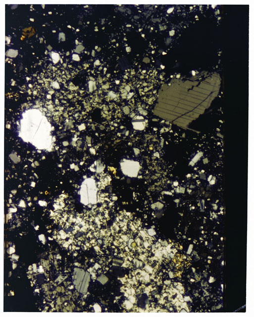 Color photograph of Apollo 16 Sample(s) 65015; 2.5x magnification of a Thin Section photograph using cross nichols light.
