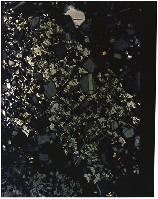 Color photograph of Apollo 16 Sample(s) 65015; 10x magnification of a Thin Section photograph using cross nichols light.
