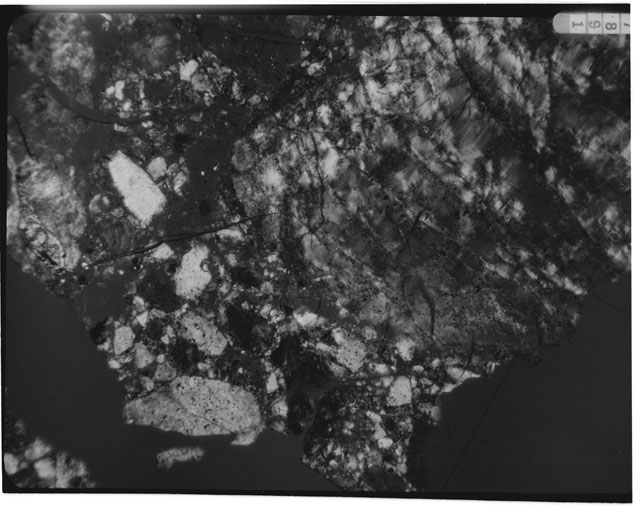 Black and white photograph of Apollo 16 Sample(s) 61016,13; 2.5x magnification of a Thin Section photograph using cross nichols light.