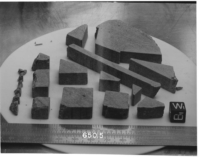 Black and white photograph of Apollo 16 Sample(s) 65015; Processing photograph displaying slab reconstruction with an orientation of W,B.