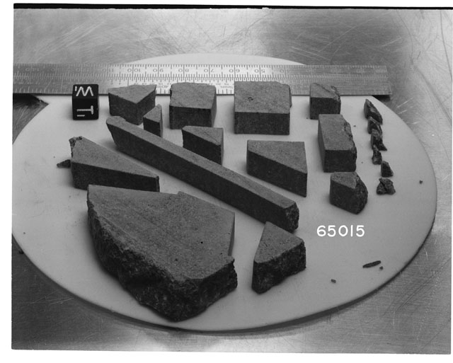 Black and white photograph of Apollo 16 Sample(s) 65015; Processing photograph displaying slab reconstruction with an orientation of W,T.