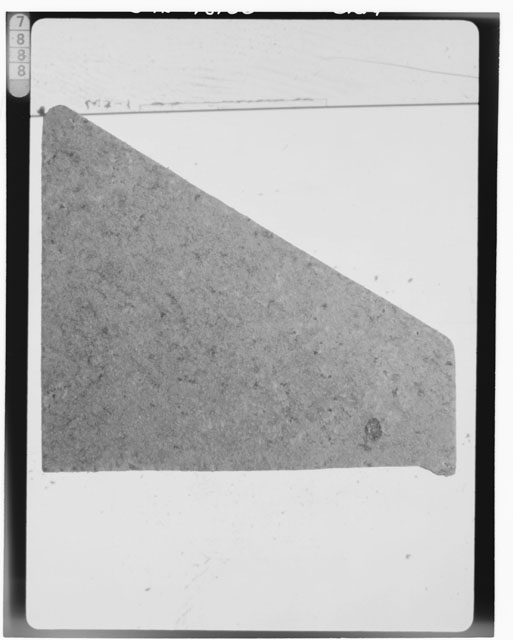 Black and white photograph of Apollo 16 Sample(s) 65015,11; Processing photograph displaying a chip.