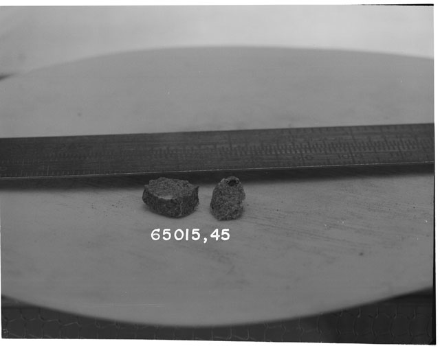 Black and white photograph of Apollo 16 Sample(s) 65015,45; Processing photograph displaying a reconstruction.