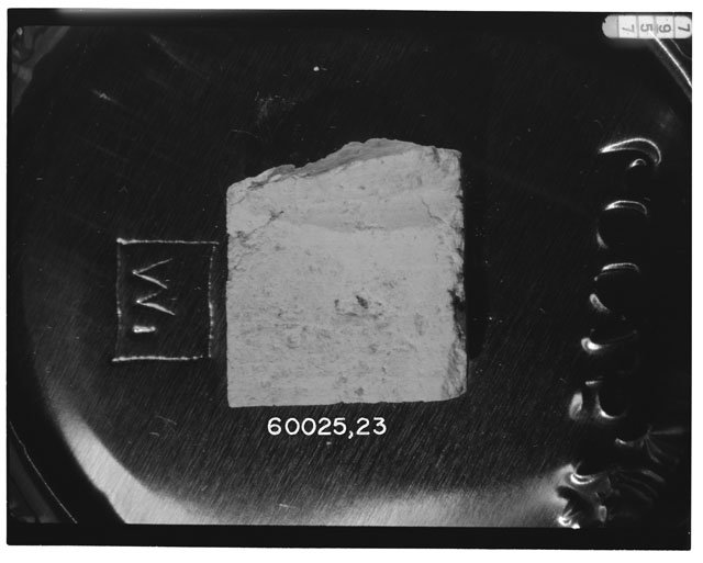 Black and white photograph of Apollo 16 Sample(s) 60025,23; Processing photograph displaying chip.