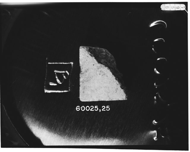 Black and white photograph of Apollo 16 Sample(s) 60025,25; Processing photograph displaying chip.